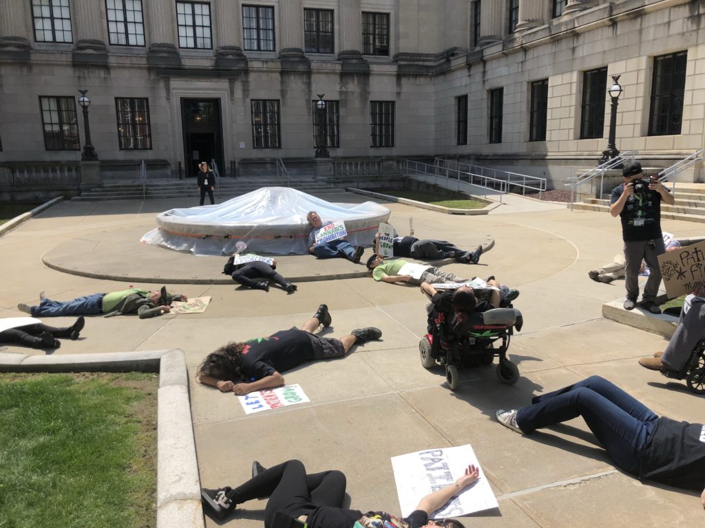 Medical marijuana advocates demonstrate at the NJ State House, pretending to be dead, to represent citizens who have died not being able to have access to the medicine they need. The advocates called out NJ Senate President Steve Sweeney for not supporting improvements to NJ's medical marijuana program and withdrawing support for legalizing home cultivation of marijuana for medical purposes.