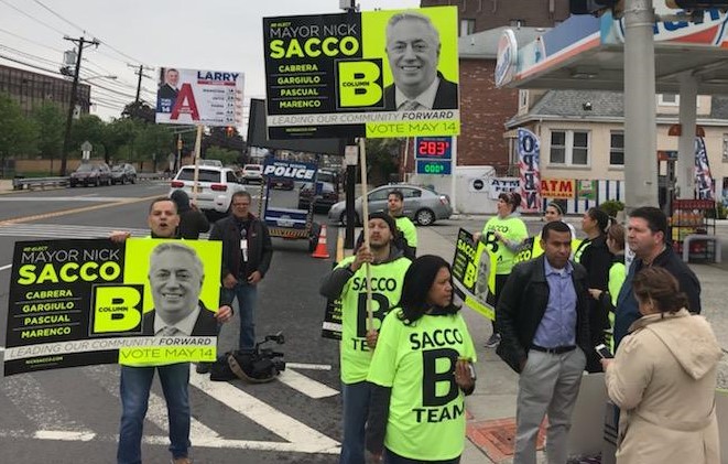 Assemblyman Pedro Mejia campaigns on a corner in North Bergen for Mayor Nick Sacco.