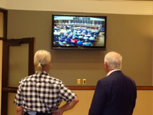 A local opponent of the project and the developer watch the Bridgewater Planning Board meeting from an overflow room in the Township Municipal Building.